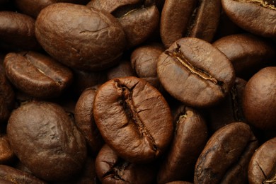 Pile of roasted coffee beans as background, closeup