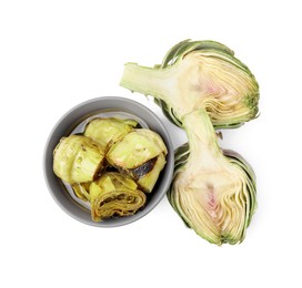 Bowl with delicious artichokes pickled in olive oil and fresh vegetables on white background, top view