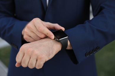 Man with smart watch outdoors, closeup view