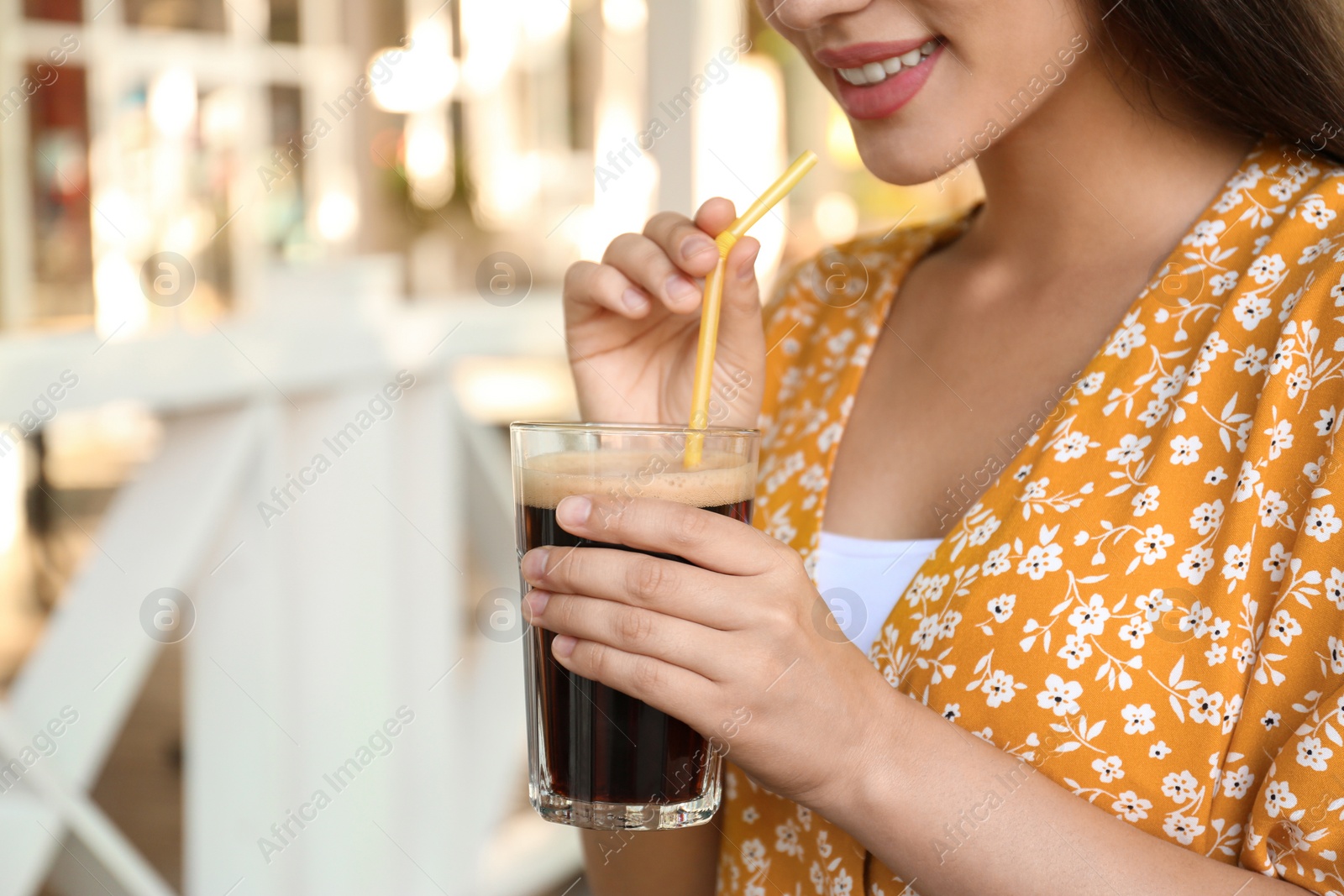 Photo of Young woman with cold kvass outdoors, closeup. Traditional Russian summer drink