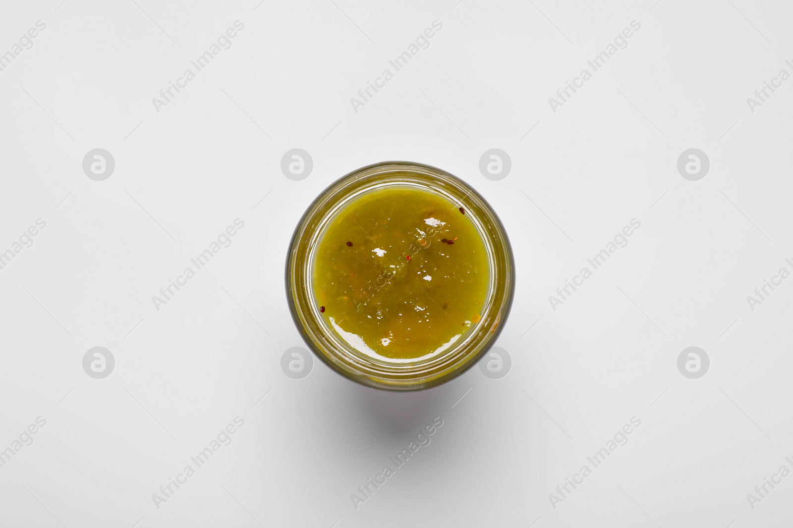 Photo of Tasty canned kiwi jam on white background, top view