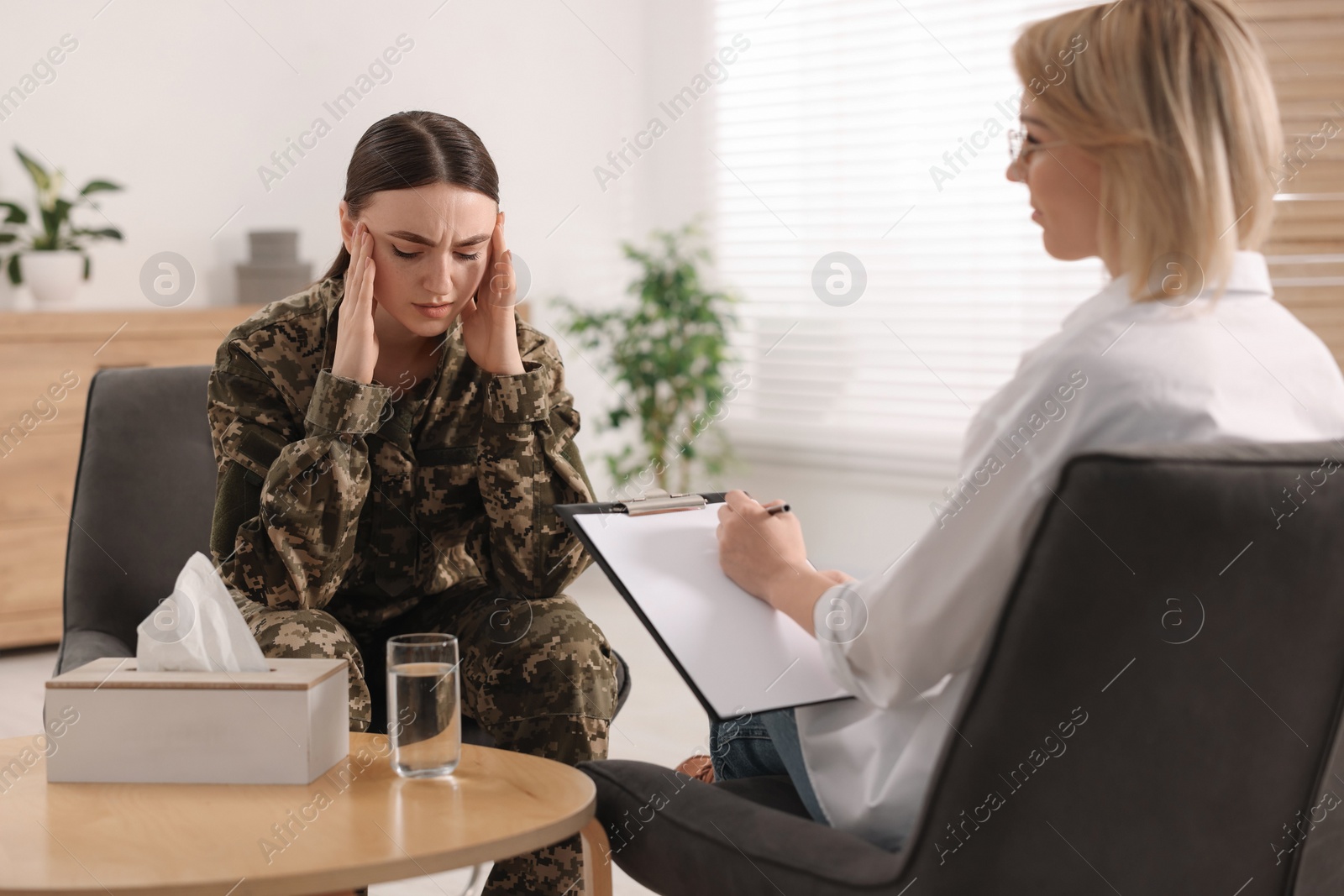 Photo of Psychotherapist working with military woman in office