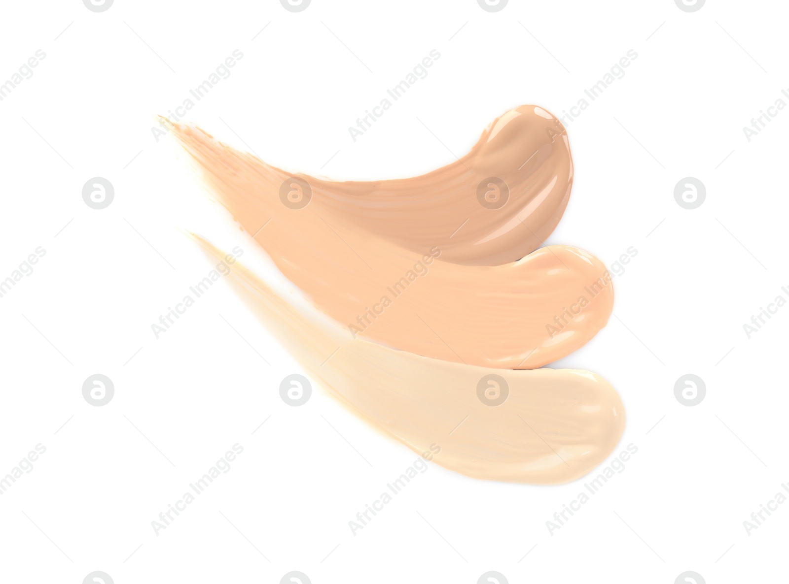 Photo of Samples of different foundation shades on white background, top view