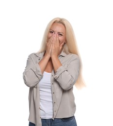 Photo of Embarrassed woman covering mouth with hands on white background