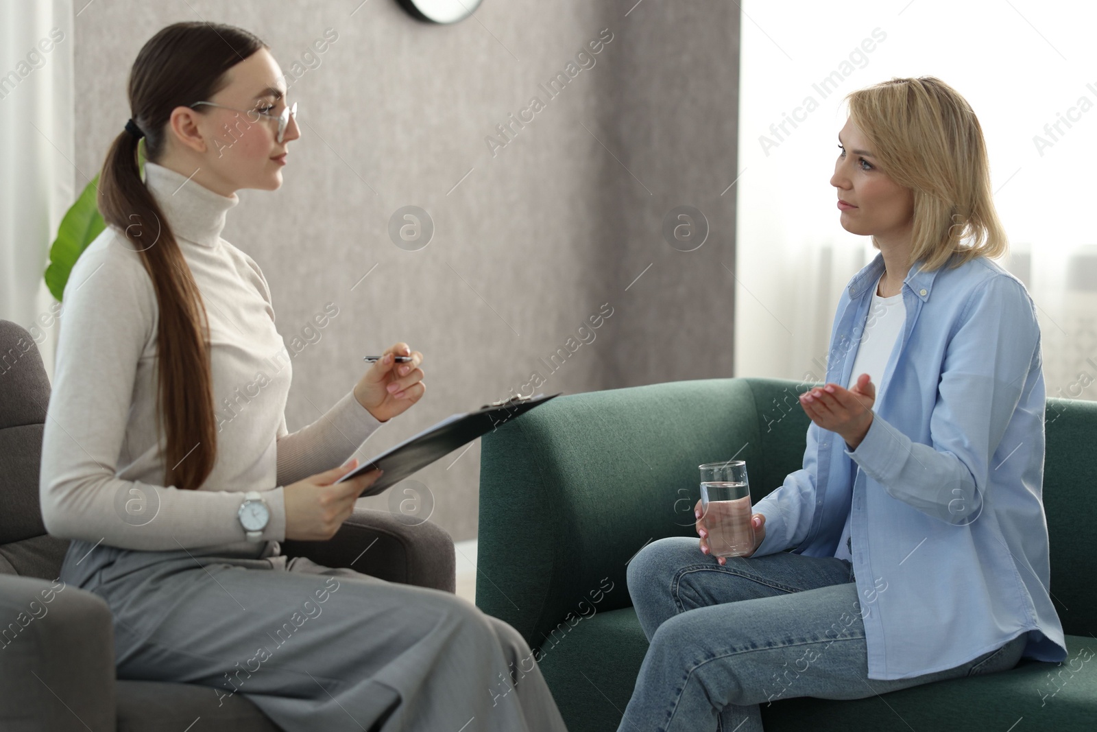 Photo of Professional psychotherapist working with patient in office