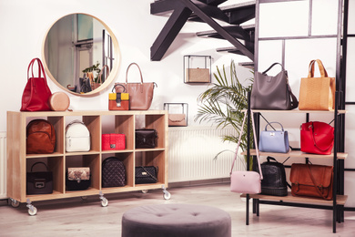 Photo of Collection of stylish woman's bags in modern store