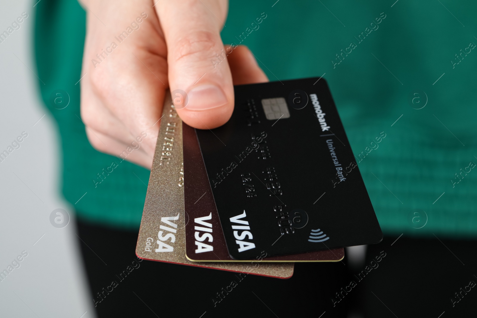 Photo of MYKOLAIV, UKRAINE - FEBRUARY 22, 2022: Woman holding Visa credit cards, closeup