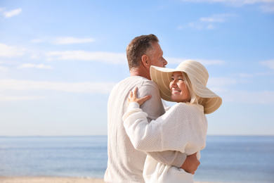 Mature couple spending time together on sea beach
