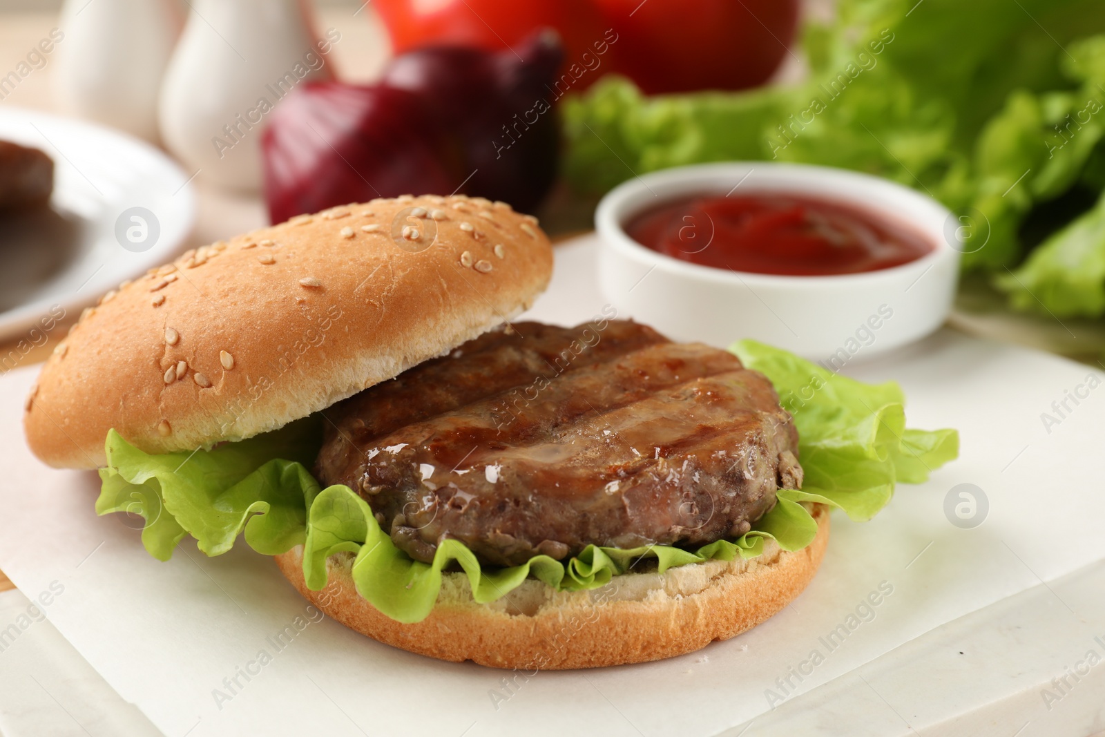 Photo of Delicious fried patty, lettuce and buns on white table, closeup. Making hamburger