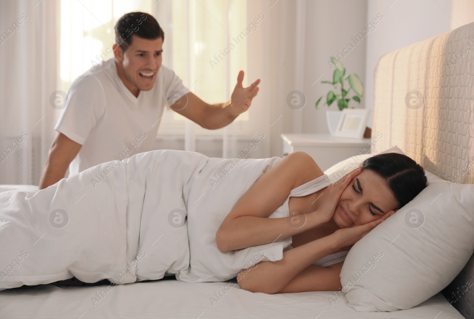 Photo of Couple with relationship problems quarreling in bedroom