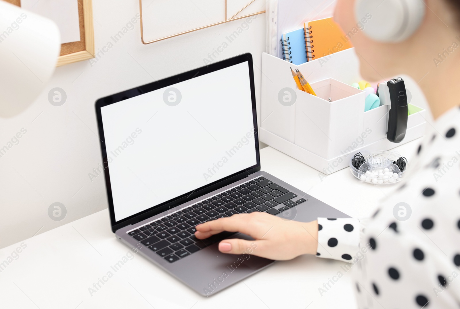 Photo of E-learning. Woman using laptop during online lesson at table indoors, closeup