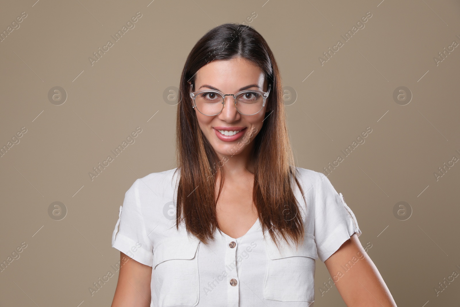 Photo of Beautiful woman in eyeglasses on beige background