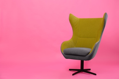 Photo of Comfortable office chair on pink background, space for text