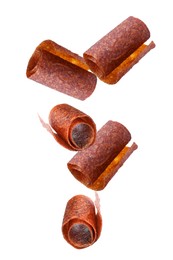 Image of Delicious fruit leather rolls falling on white background