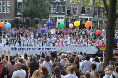 Photo of AMSTERDAM, NETHERLANDS - AUGUST 06, 2022: Many people at LGBT pride parade on summer day