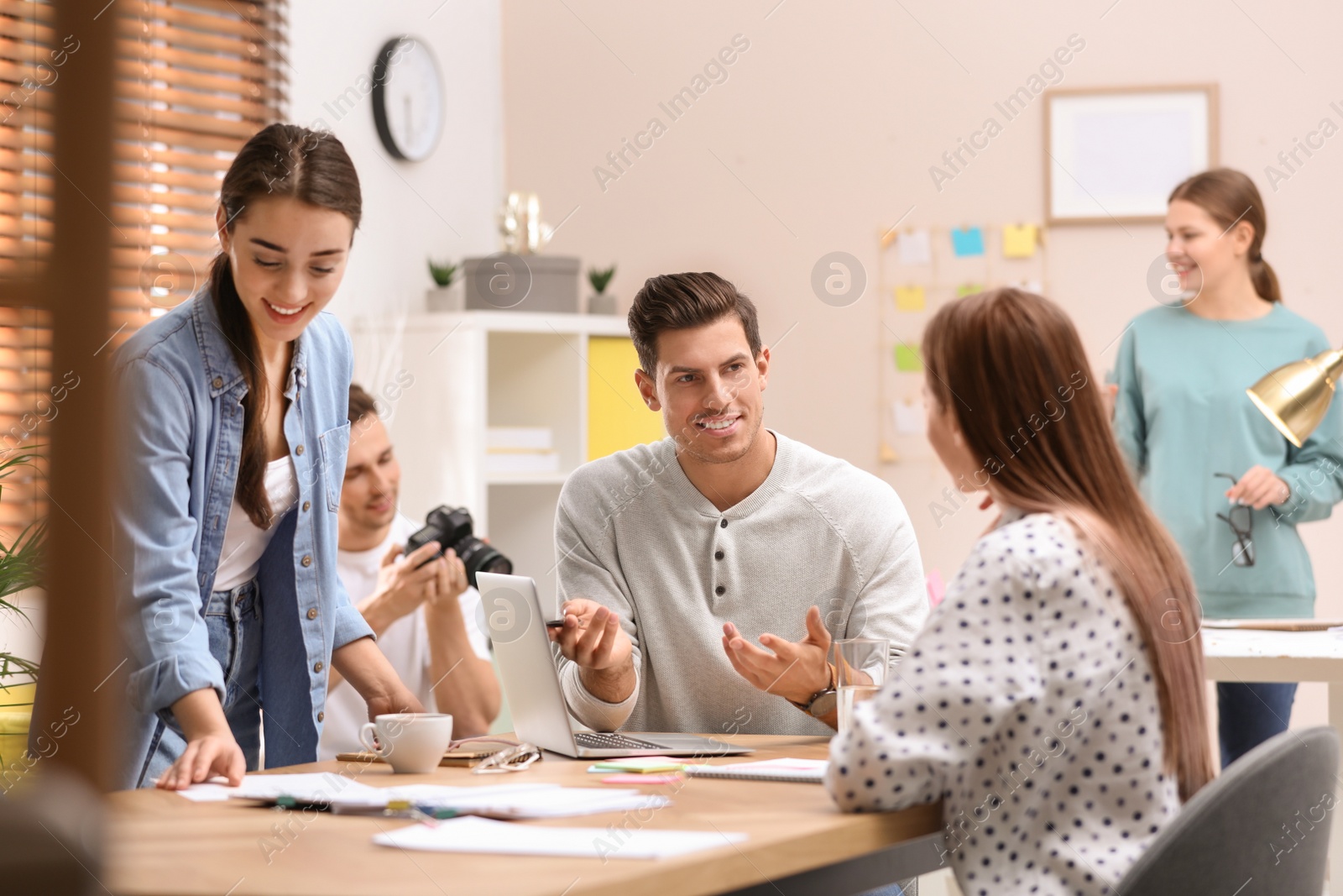 Photo of Team of professional journalists working in office