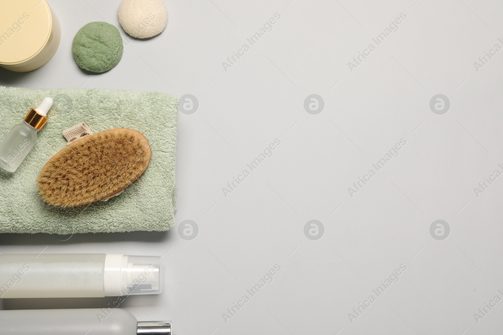 Photo of Bath accessories. Flat lay composition with personal care products on light grey background, space for text