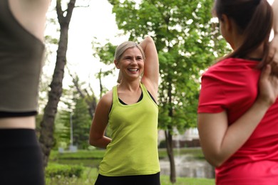 Photo of Women doing morning exercise together in park