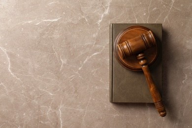 Photo of Wooden gavel and book on table, top view. Law concept