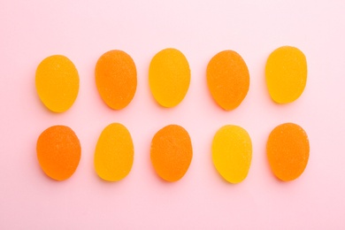 Photo of Tasty bright jelly candies on color background, top view