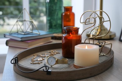 Stylish tray with different interior elements on wooden table near window