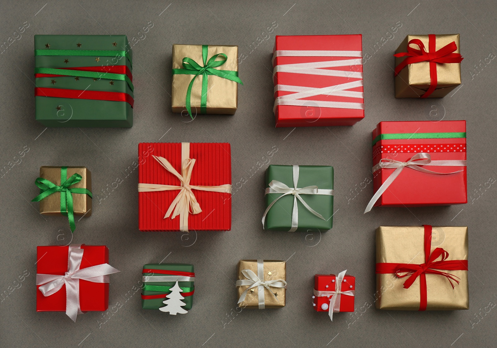 Photo of Flat lay composition with Christmas gift boxes on grey background