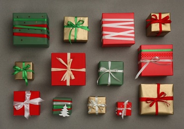 Flat lay composition with Christmas gift boxes on grey background