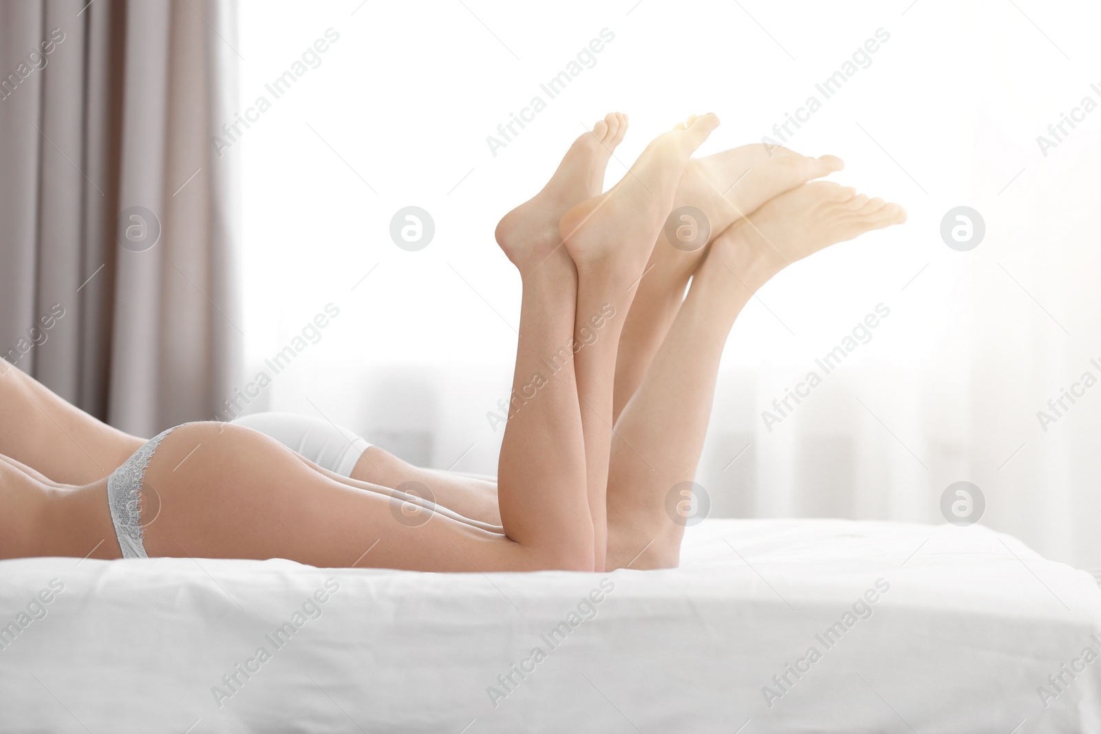 Image of Lovely young couple lying on bed at home