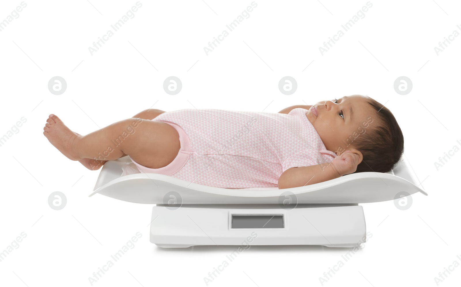 Photo of African-American baby lying on scales against white background