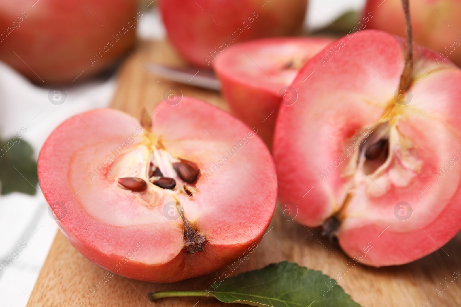 Photo of Tasty apples with red pulp on table, closeup