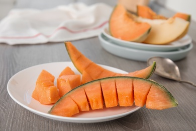 Slices of ripe cantaloupe melon on wooden table