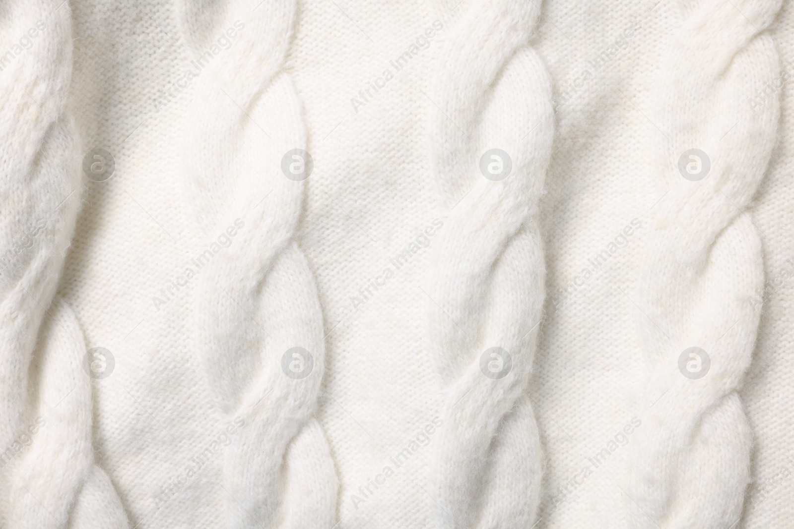 Photo of Texture of soft white knitted fabric as background, top view