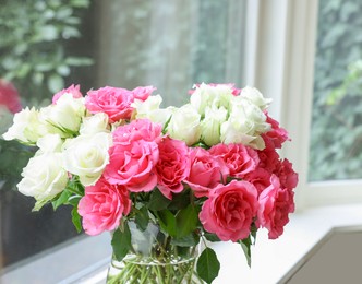 Photo of Vase with beautiful bouquet of roses on windowsill indoors. Space for text