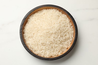 Photo of Raw basmati rice in bowl on white table, top view