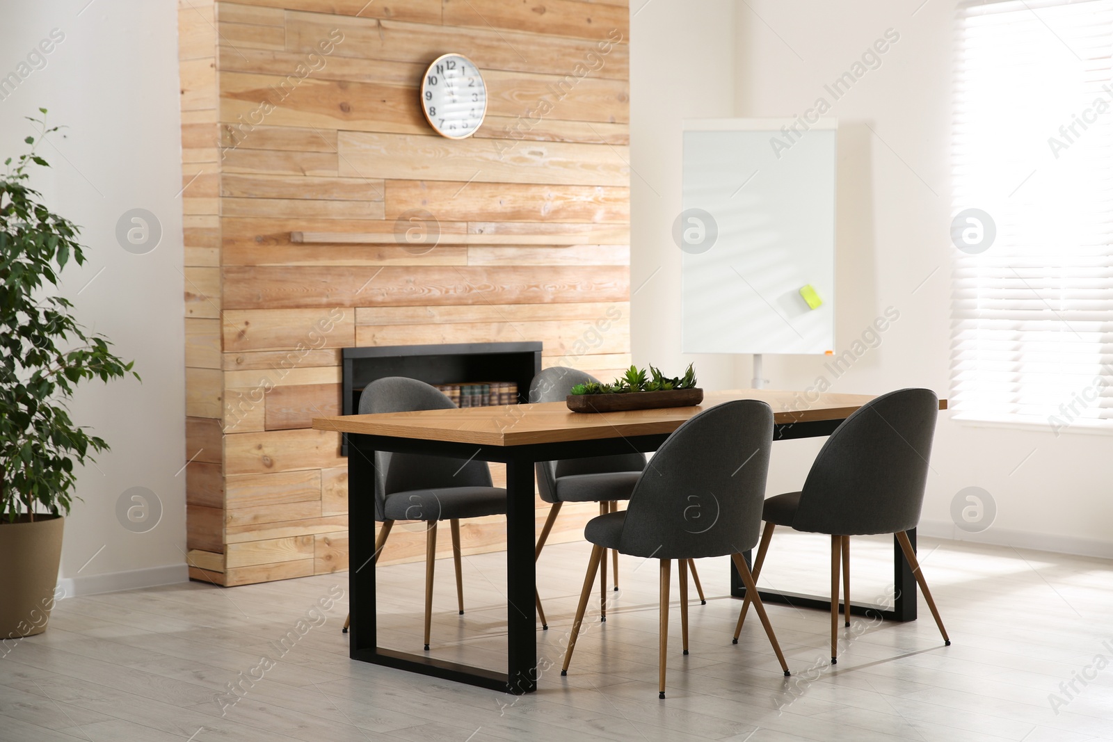 Photo of Modern meeting room interior with large table and chairs