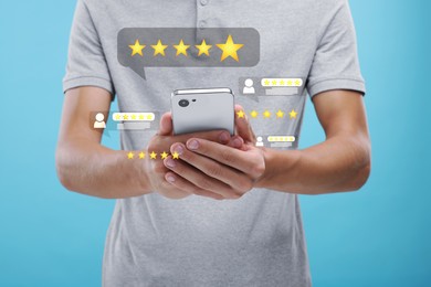 Man looking through service feedbacks with smartphone on light blue background, closeup. Reviews and stars near device