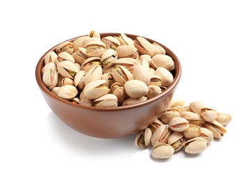 Tasty organic pistachio nuts in bowl on white background