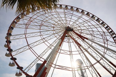 BATUMI, GEORGIA - MAY 31, 2022: Beautiful Ferris wheel outdoors, low angle view