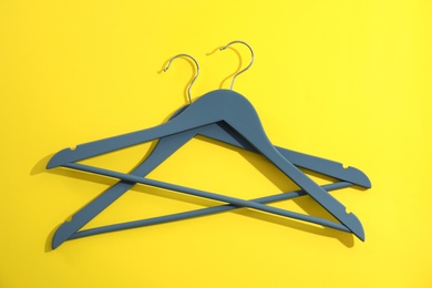 Photo of Flat lay composition with empty hangers on color background