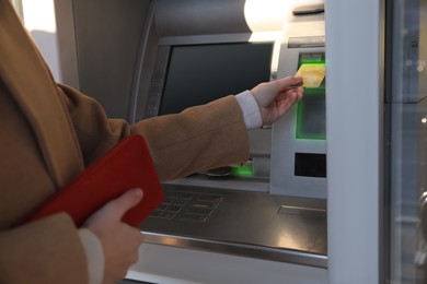 Image of Young woman using cash machine for money withdrawal outdoors, closeup