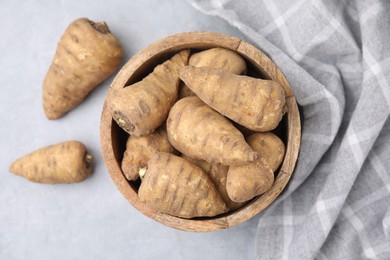 Tubers of turnip rooted chervil on light grey table, top view