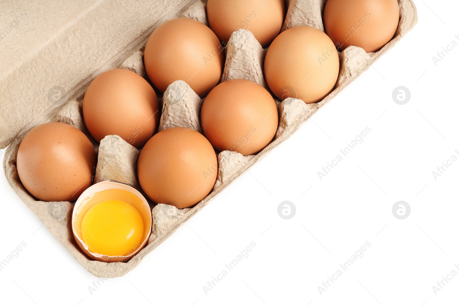 Photo of Chicken eggs in carton isolated on white, top view