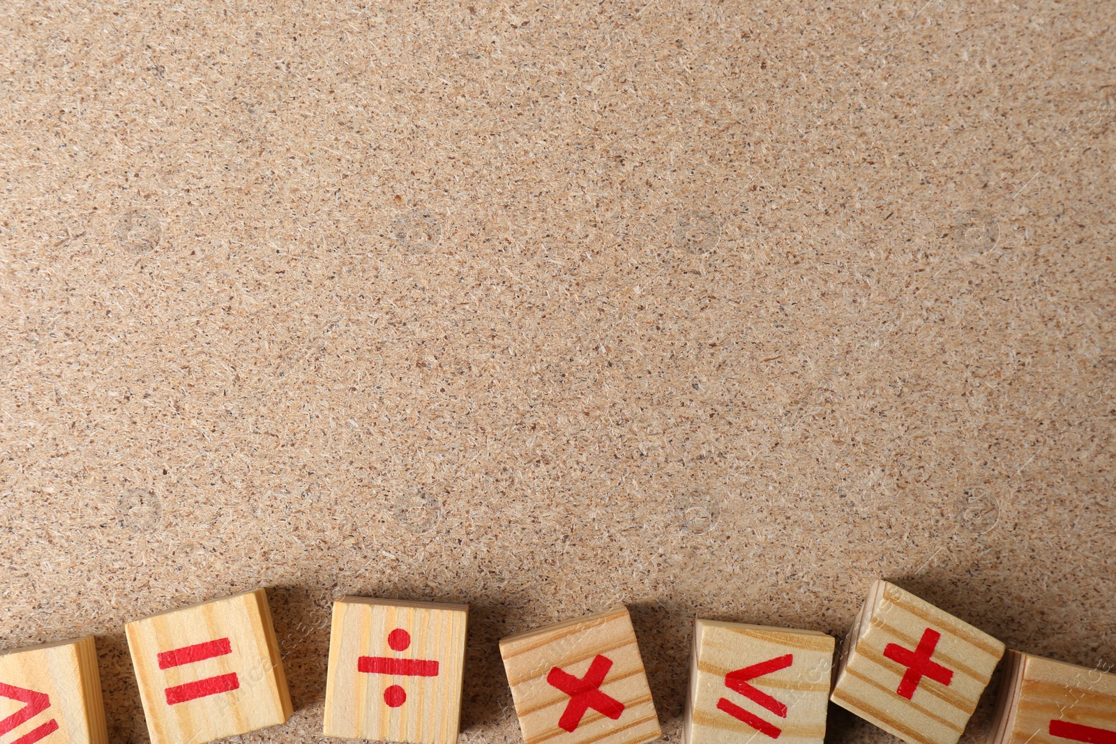 Photo of Wooden cubes with mathematical symbols on fiberboard, flat lay. Space for text