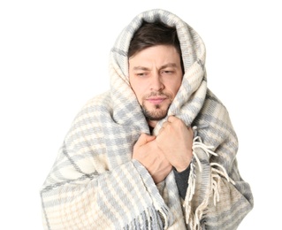 Man wrapped in blanket suffering from cold on white background