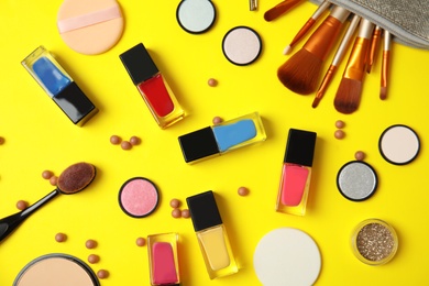 Flat lay composition with bottles of nail polish and different cosmetics on color background