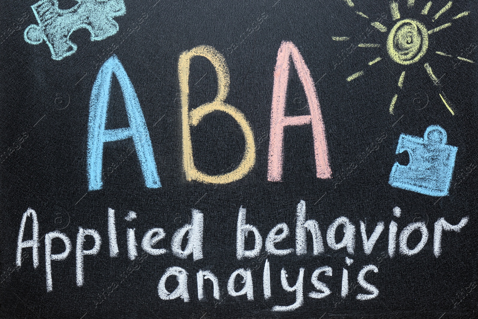 Photo of Text ABA Applied behavior analysis and drawings on blackboard