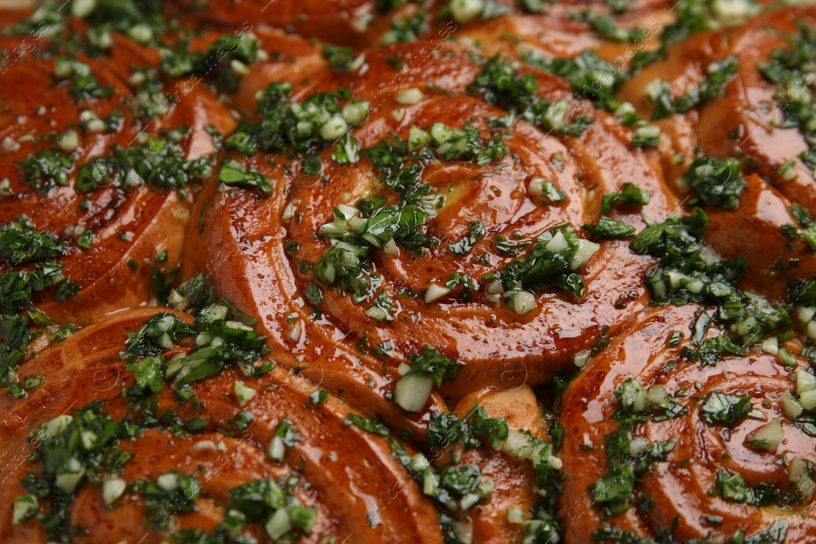 Photo of Traditional Ukrainian garlic bread with herbs (Pampushky), closeup view