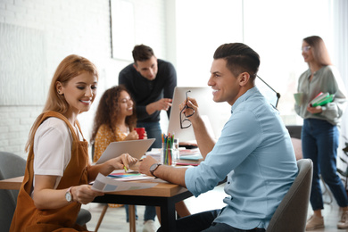 Photo of Team of professional designers working in office