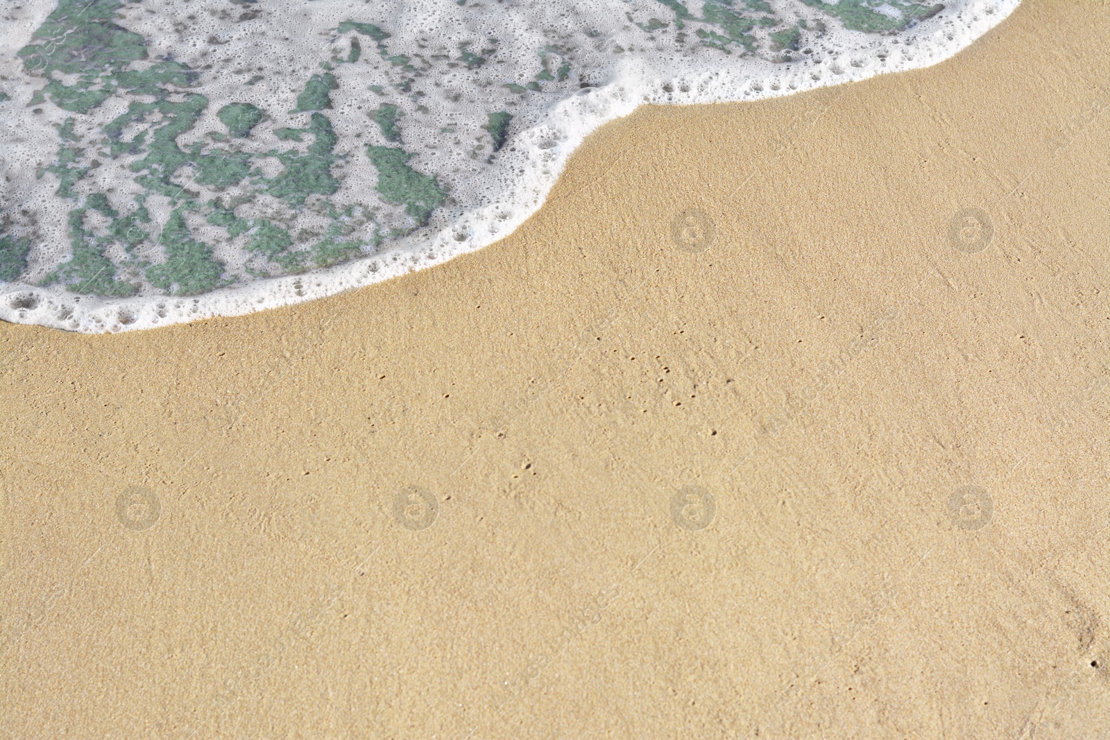 Photo of Beautiful foamy sea tide on sandy beach