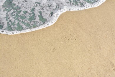 Photo of Beautiful foamy sea tide on sandy beach